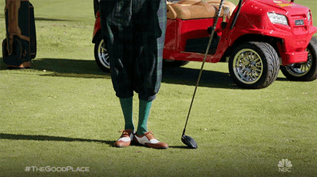 a man is holding a golf club on a golf course with a nbc logo in the background
