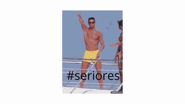 a shirtless man in yellow shorts is standing on a boat with #seriores written on the bottom