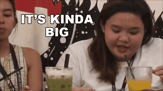 a woman says it 's kinda big while drinking a green drink