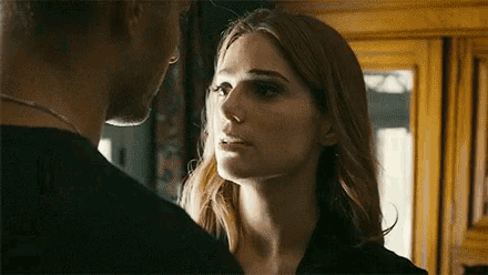 a man and a woman are looking at each other . the woman is looking at the man 's face .