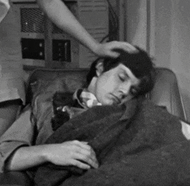 a black and white photo of a man laying down