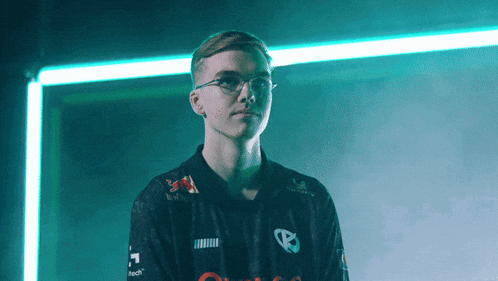 a man wearing glasses and a black shirt with a red bull logo
