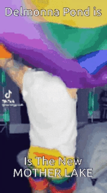 a person holding a rainbow flag with the words delmonna pond is the new mother lake on the bottom