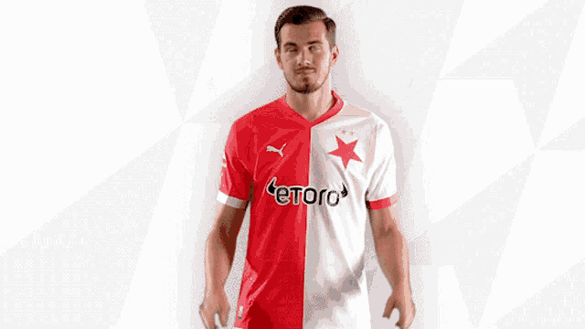 a man wearing a red and white jersey that says etoro on it