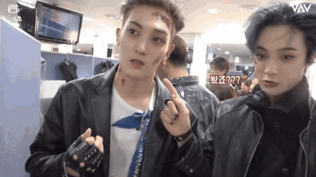 two young men are standing next to each other and one has a bandage on his forehead