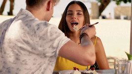 a man is feeding a woman a piece of cake