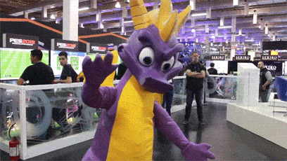 a purple and yellow dragon mascot stands in front of a sign that says " pes 2019 "