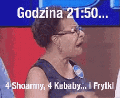 a woman with glasses is sitting in front of a screen that says godzina 21:50 4 shoarmy 4 kebaby i frytki