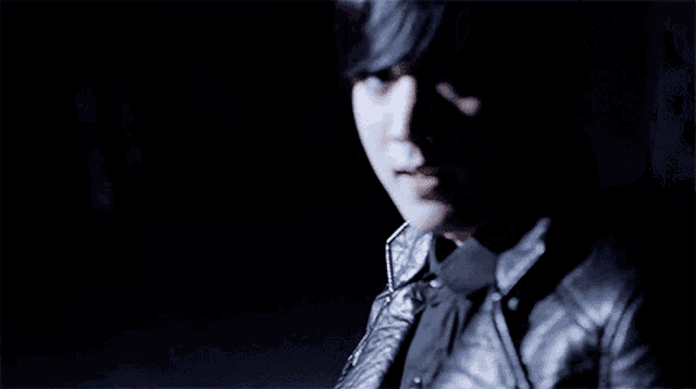a close up of a person 's face with a black background