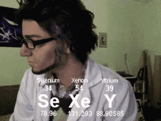 a man wearing glasses and a lab coat with selenium xenon and mttrium written on it