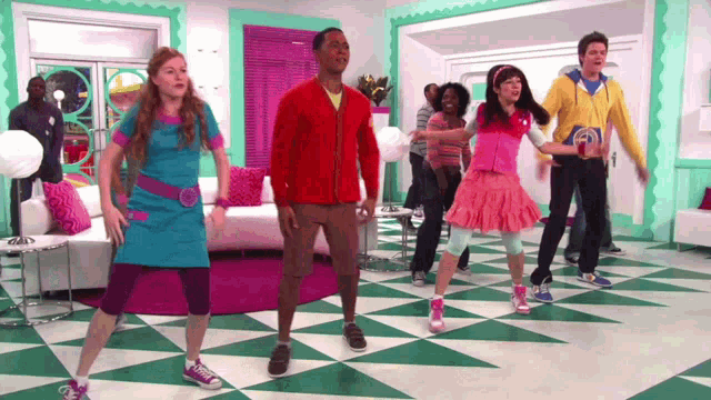 a group of people are dancing in a room