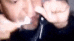 a person is brushing their teeth with a toothbrush while holding a key .
