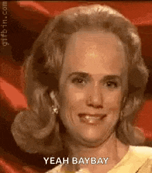 a woman with a bald head is smiling and saying yeah bay bay .