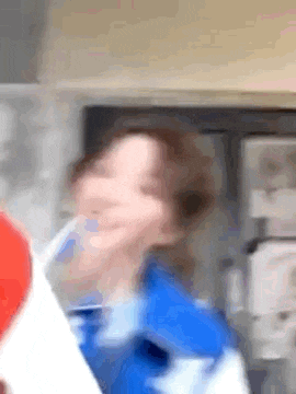 a blurry picture of a person holding a red balloon .