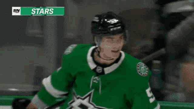 a hockey player is wearing a green jersey with a star on the front