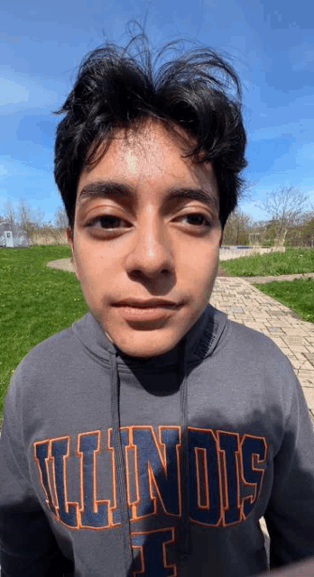 a young man wearing a hoodie that says illinois