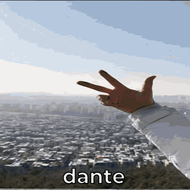 a person making a peace sign with their fingers and the word dante below