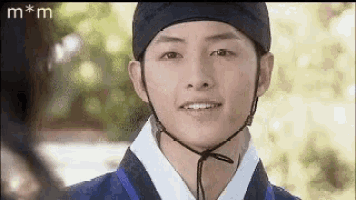 a close up of a man wearing a helmet and a costume .