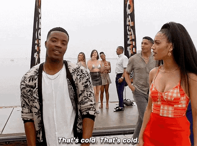 a man and woman are standing next to each other and the woman is saying that 's cold .