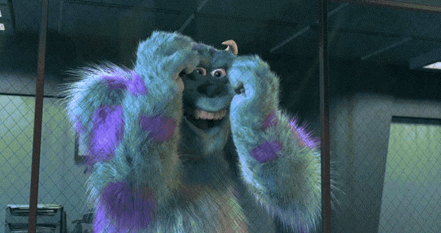 sulley from monsters inc is smiling and covering his face with his hands