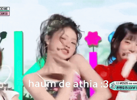 a girl with a flower in her hair is dancing in front of a sign that says " haum de athia "