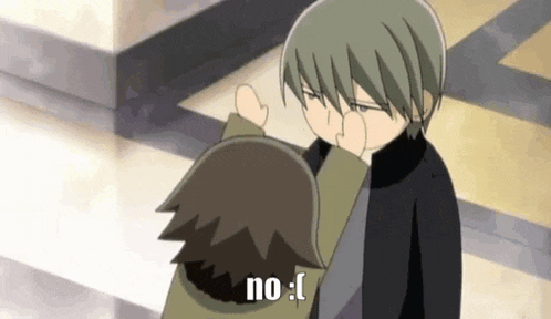 a couple of anime characters are standing next to each other and one of them is making a funny face .