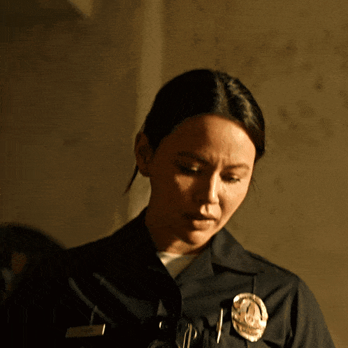 a woman in a police uniform has a badge on her chest that says los angeles