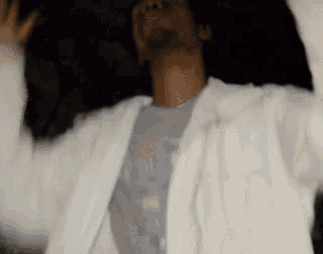 a blurry picture of a man in a white jacket