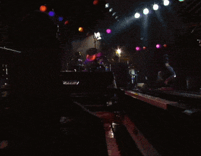 a man in a striped shirt is playing a keyboard
