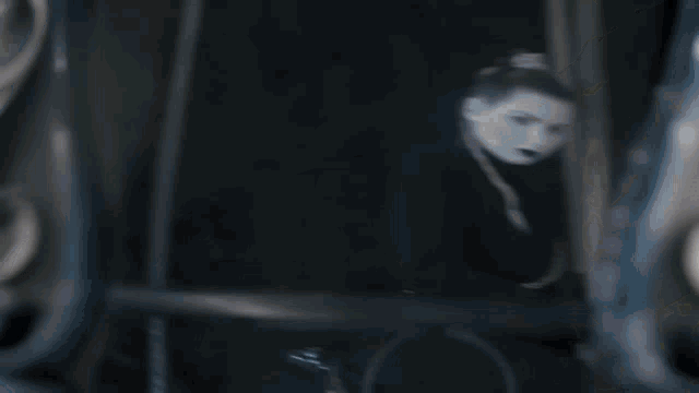 a blurred image of a person behind bars with a blue tie