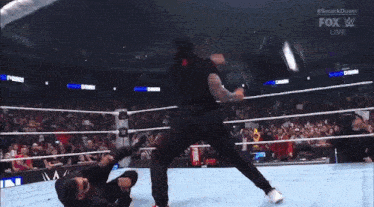 two men are wrestling in a wrestling ring .