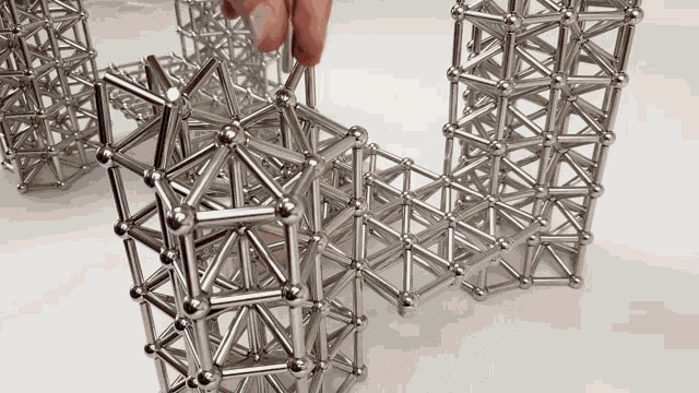 a person is playing with a set of magnets and balls