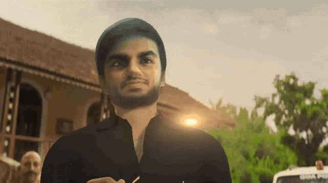 a man with a beard is standing in front of a building that says goa police