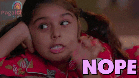 a little girl is covering her face with her hand and the word nope is above her .