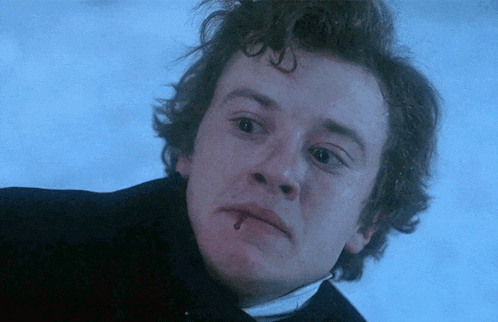 a close up of a man with a bloody mouth