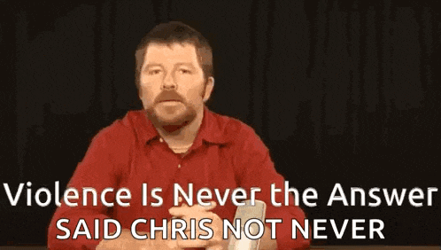 a man in a red shirt is sitting at a table and talking about violence is never the answer , said chris not never .