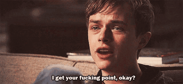 a man is sitting on a couch and says i get your fucking point okay
