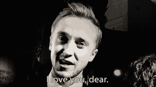 a man with a beard is smiling and saying `` i love you , dear . ''