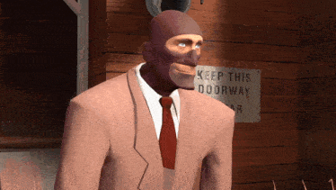 a man in a suit stands in front of a keep this doorway sign