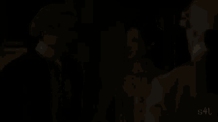 a man and woman are standing next to each other in a room .