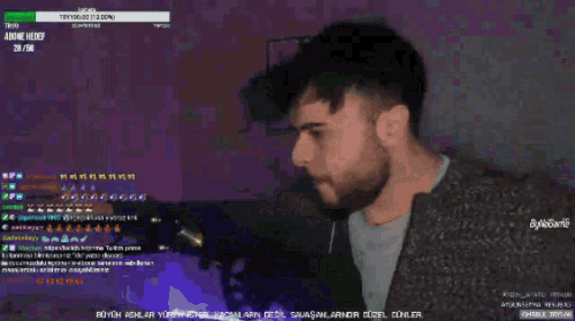 a man with a beard is playing a video game on a computer