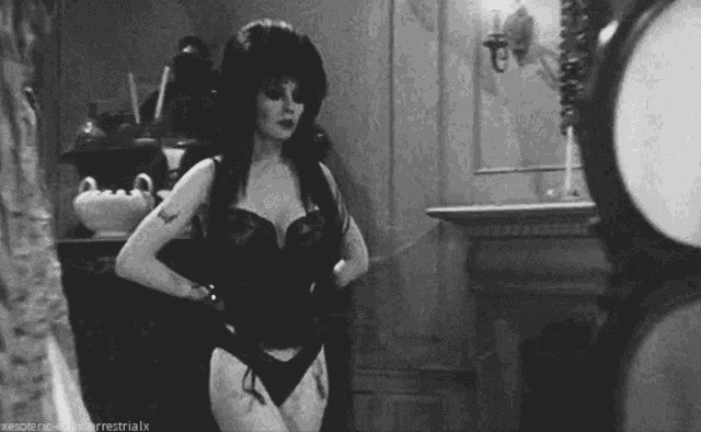 a black and white photo of a woman in a corset and gloves with a watermark that says xesoteric