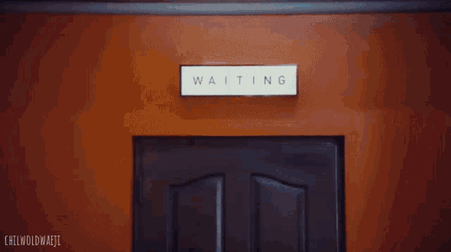 a woman in a blue suit is standing in a doorway with the words chilwoldmajii written below her