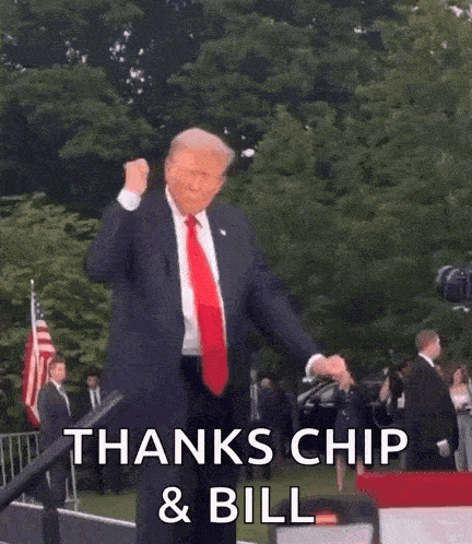 a man in a suit and tie is dancing in front of a microphone and a sign that says thanks chip and bill .