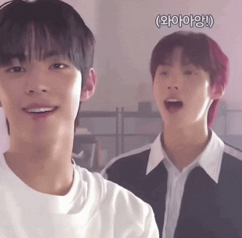 two young men are standing next to each other and one of them has red hair