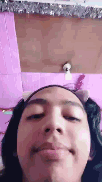 a close up of a person 's face with a cat ear headband