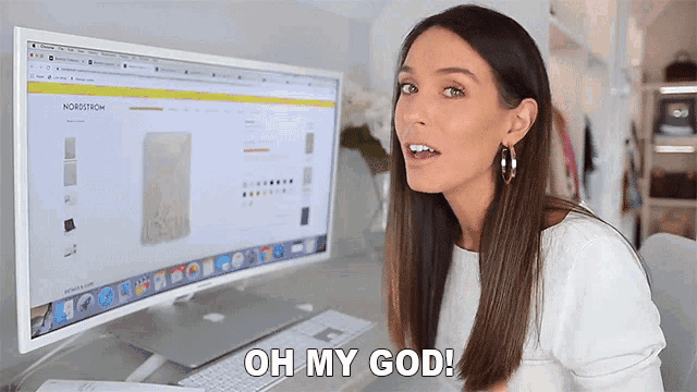 a woman sitting in front of a computer with the words oh my god on her face