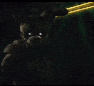 a dark cartoon character with glowing eyes is standing in the dark .