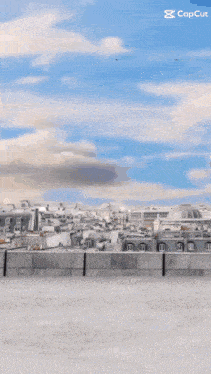 a person is walking on a rooftop with a city in the background and the caption capcut
