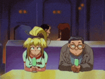 a man and a girl are sitting at a table and the girl is wearing a shirt that says london